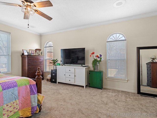 carpeted bedroom featuring crown molding and ceiling fan