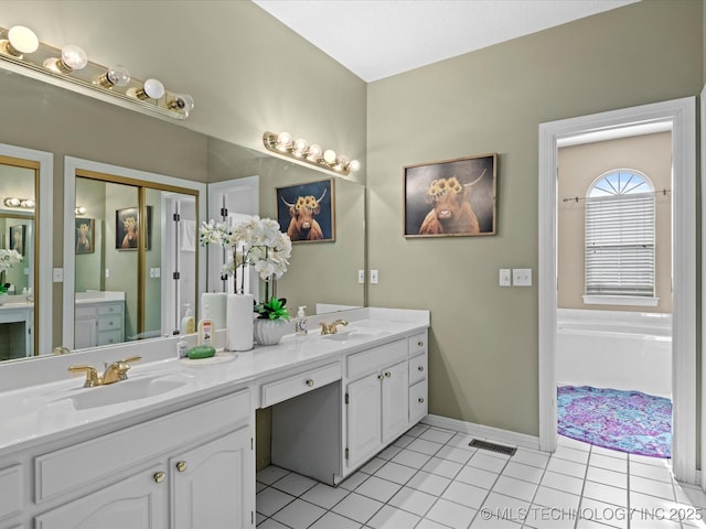 bathroom with vanity, a tub to relax in, and tile patterned floors