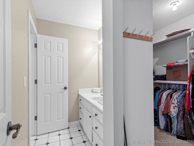 bathroom with vanity and a textured ceiling