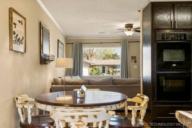 dining area with ceiling fan, crown molding, and a textured ceiling