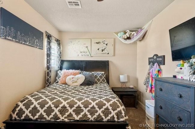 carpeted bedroom with a textured ceiling