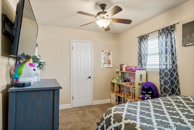 carpeted bedroom with ceiling fan and a textured ceiling