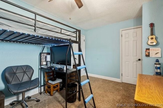 bedroom featuring carpet flooring and a textured ceiling