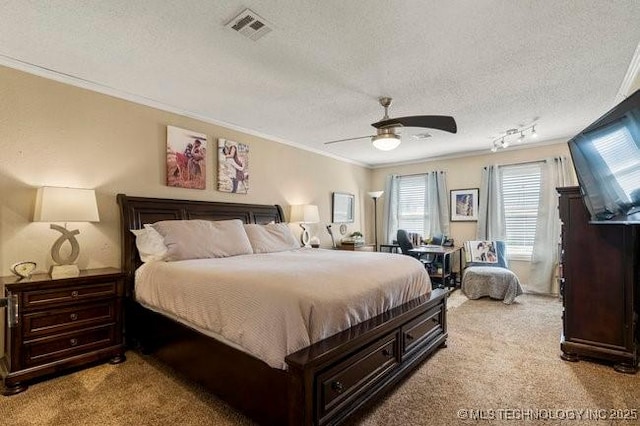 carpeted bedroom with ceiling fan, crown molding, and a textured ceiling