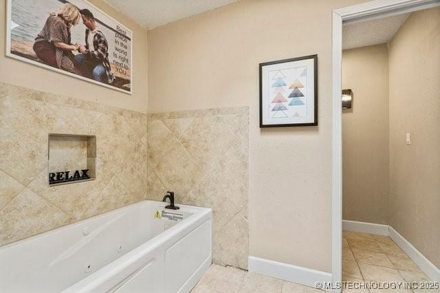 bathroom with tile patterned flooring and a tub