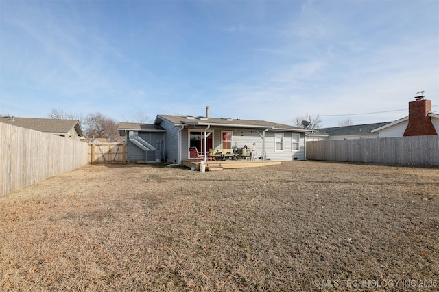 rear view of house featuring a lawn and a patio area