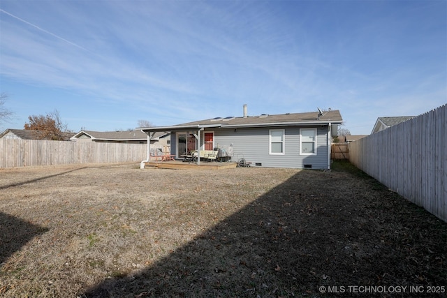 back of property featuring a lawn and a patio