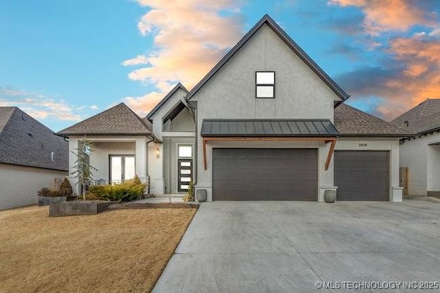 view of front of home featuring a garage and a lawn