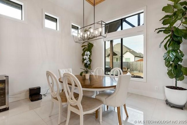 tiled dining room with an inviting chandelier and wine cooler