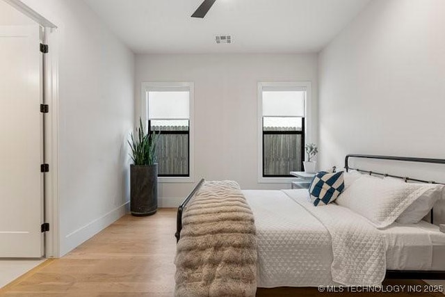 bedroom with ceiling fan and light hardwood / wood-style flooring