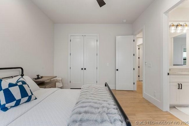 bedroom featuring connected bathroom, a closet, ceiling fan, and light wood-type flooring