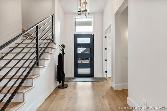 entryway featuring an inviting chandelier and light wood-type flooring