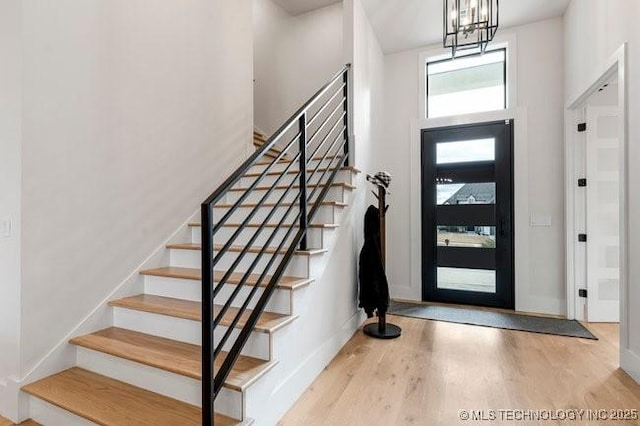 foyer with an inviting chandelier and light hardwood / wood-style floors