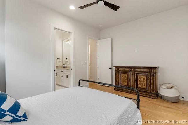 bedroom featuring hardwood / wood-style flooring, ceiling fan, and ensuite bath