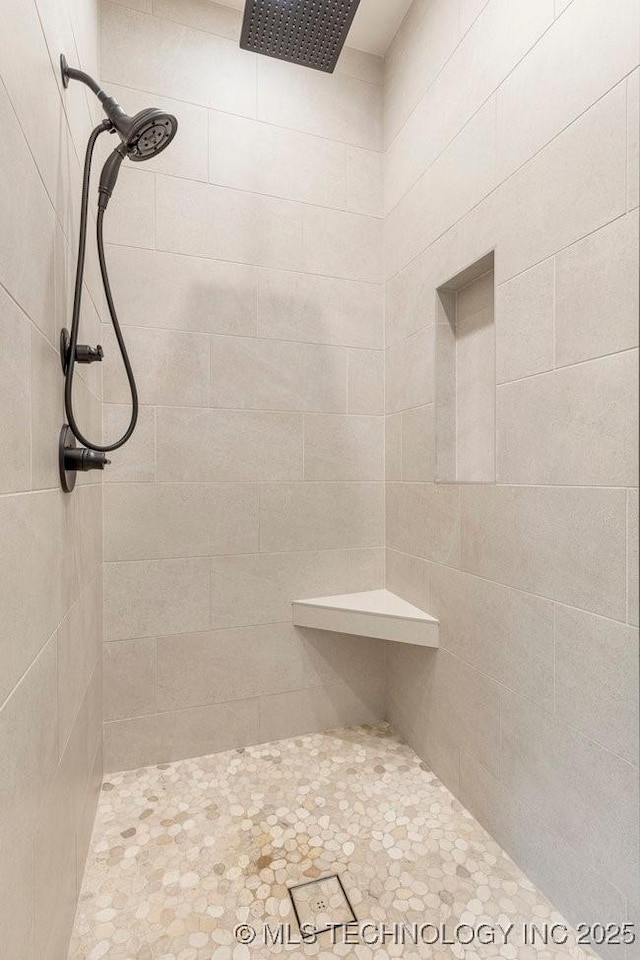 bathroom with tiled shower