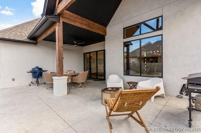 view of patio with area for grilling and ceiling fan