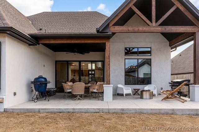 back of property with a patio area and ceiling fan