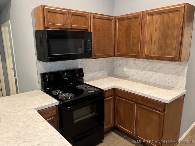 kitchen with tasteful backsplash and black appliances