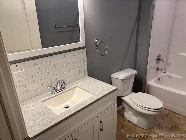 full bathroom featuring backsplash, tile patterned flooring, vanity, shower / bath combination, and toilet