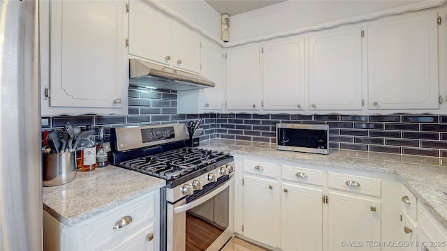 kitchen with white cabinetry, appliances with stainless steel finishes, and decorative backsplash