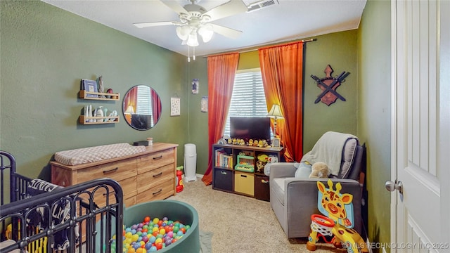 bedroom with light colored carpet and ceiling fan