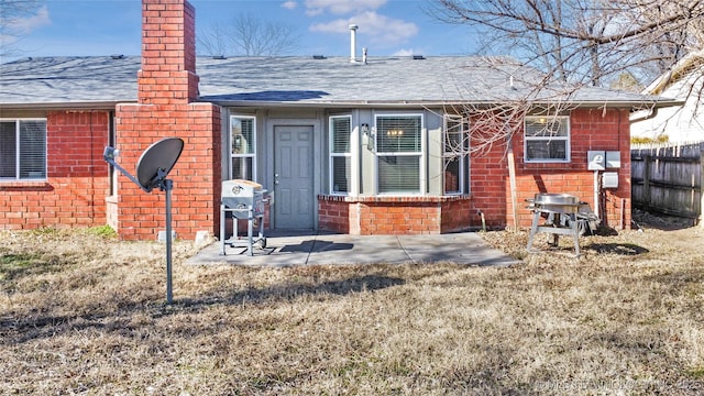 back of house featuring a patio and a lawn