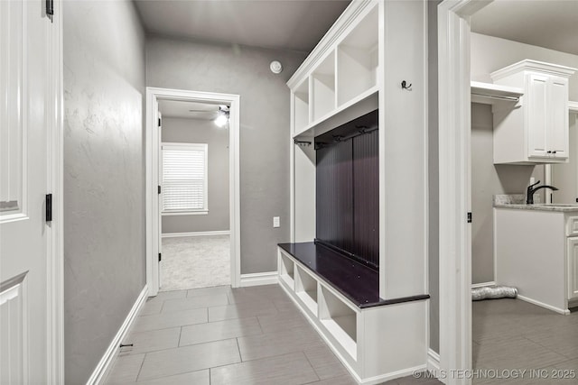 mudroom with light tile patterned flooring and ceiling fan