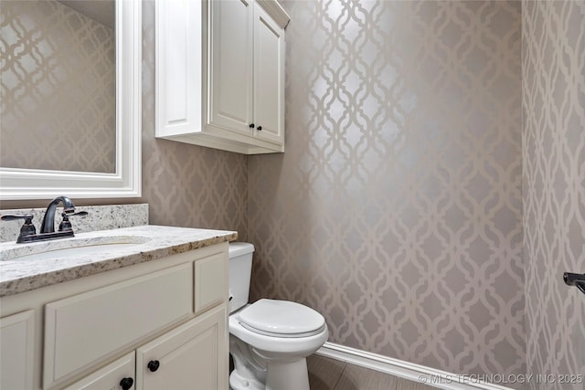 bathroom with vanity and toilet