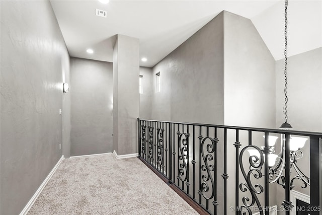 corridor featuring vaulted ceiling and carpet