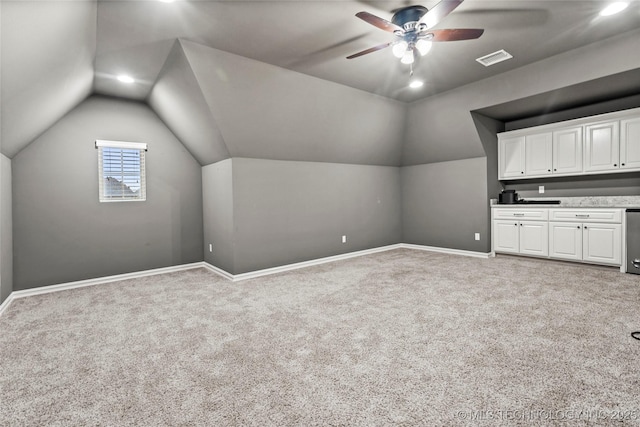 bonus room featuring lofted ceiling, light carpet, and ceiling fan