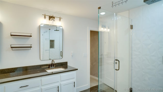 bathroom with vanity and a shower with door