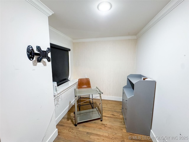 living area with crown molding and wood-type flooring