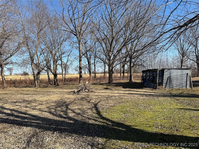 view of yard featuring an outbuilding and a rural view