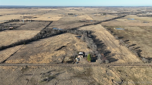 birds eye view of property with a rural view