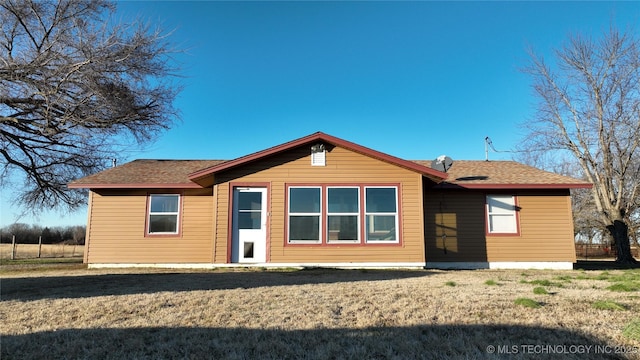 back of house with a lawn