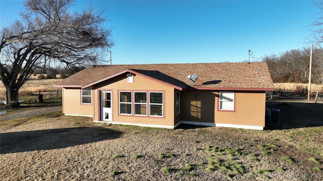 rear view of property featuring central AC unit