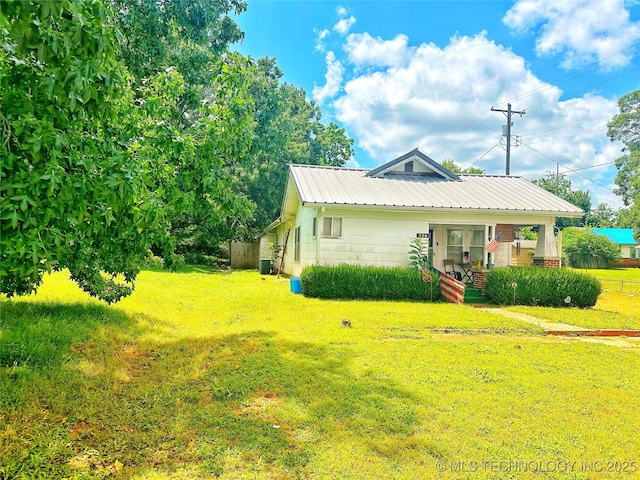 view of side of property with a lawn