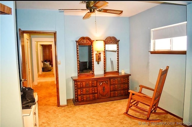 living area with light colored carpet and ceiling fan