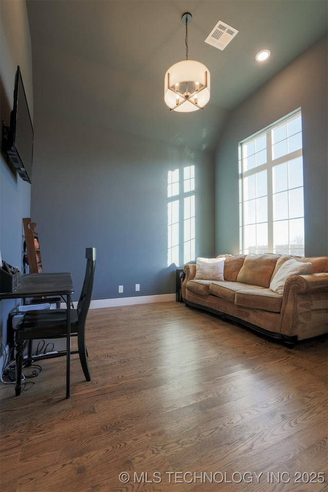 office area with dark hardwood / wood-style flooring, a wealth of natural light, and a chandelier