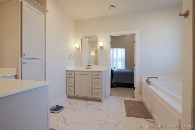 bathroom with vanity and a tub