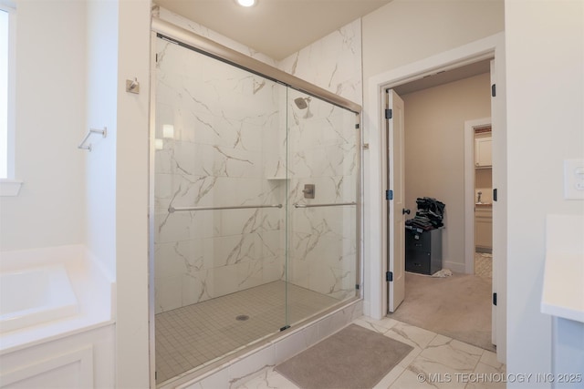 bathroom with a shower with door