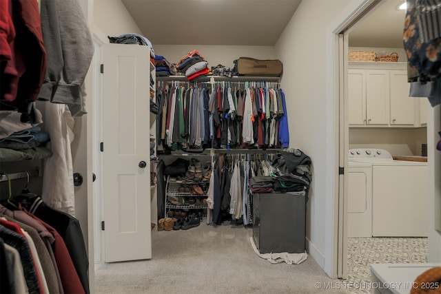 walk in closet featuring light carpet and washer and dryer