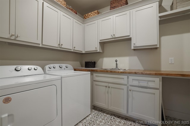 laundry area with cabinets, sink, and washing machine and clothes dryer