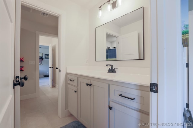 bathroom featuring tile patterned floors, vanity, and curtained shower