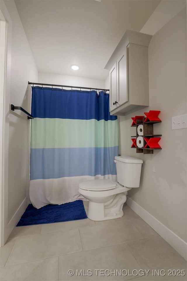 bathroom featuring tile patterned flooring, a shower with curtain, and toilet