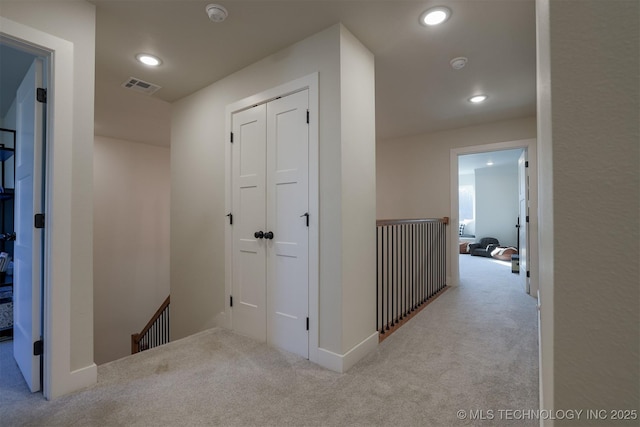 hallway featuring light carpet