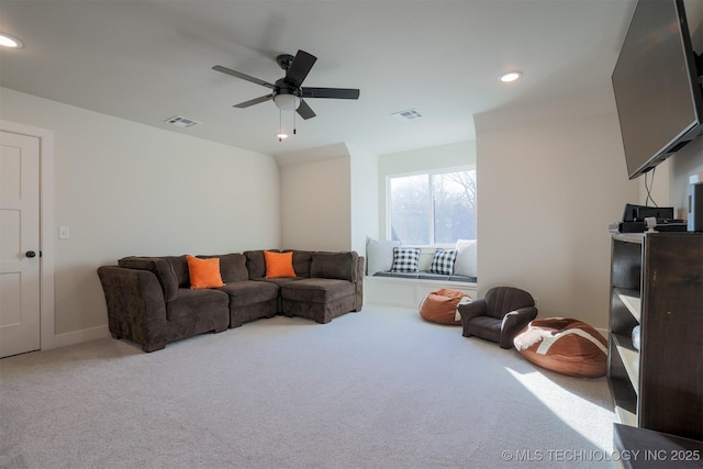 living room with ceiling fan and carpet