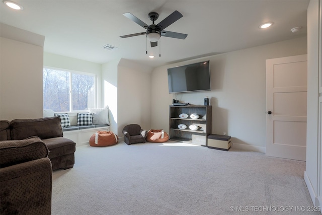 living room featuring ceiling fan and light colored carpet