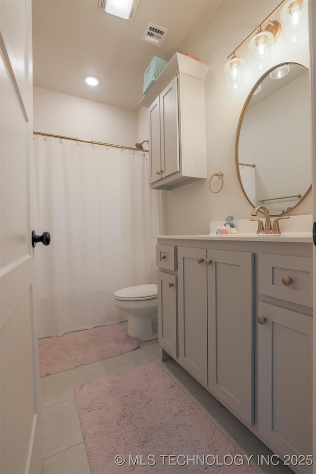 bathroom with tile patterned floors, toilet, and vanity