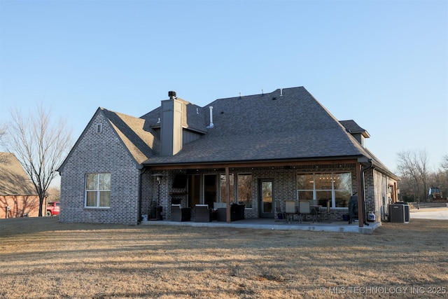 back of house featuring cooling unit, a yard, and a patio area